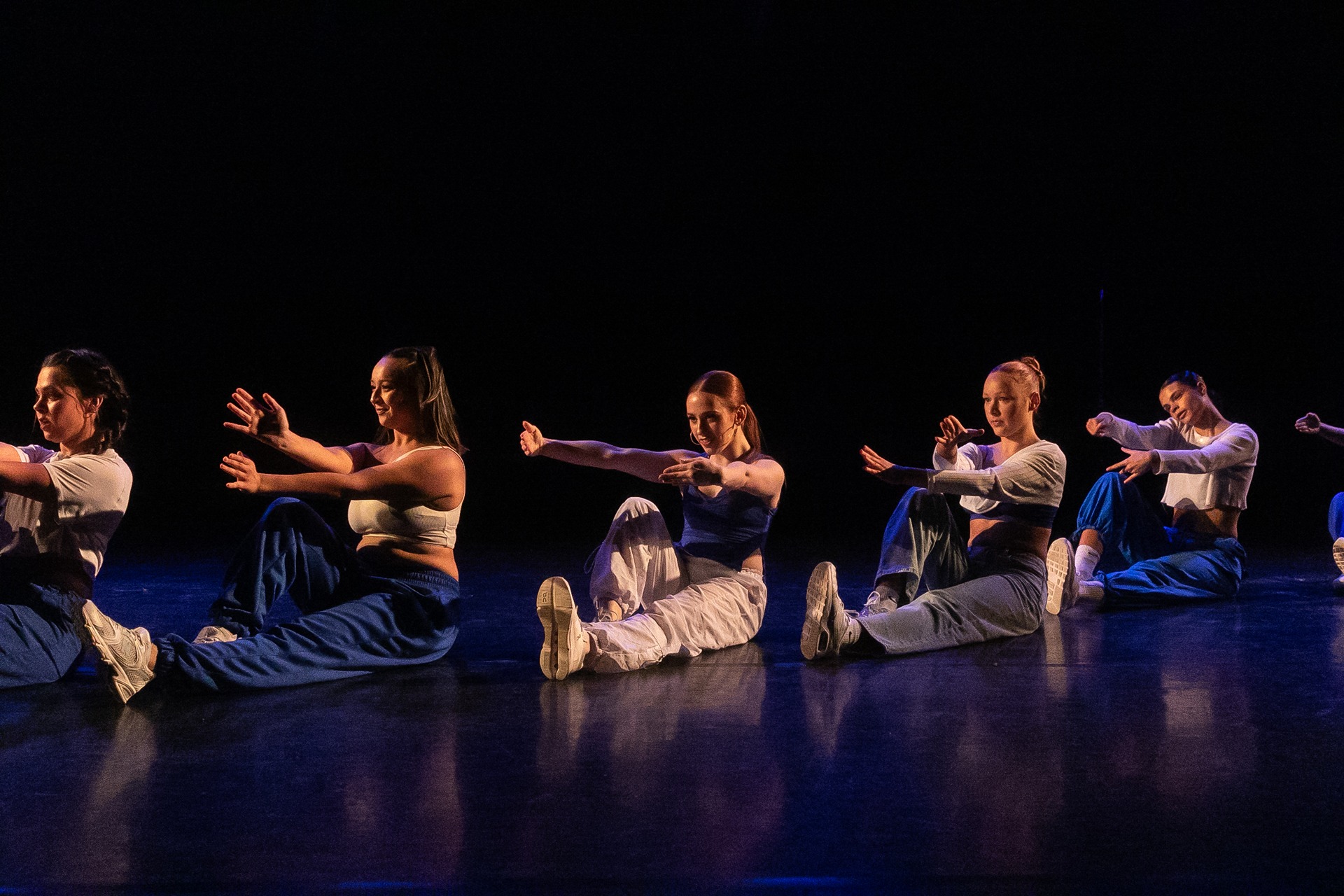Students dancing on the floor in sync.