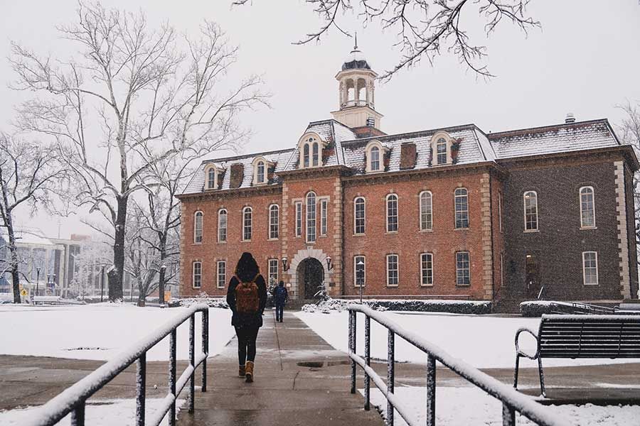 Martin Hall in winter with light snow on Woodburn Circle.