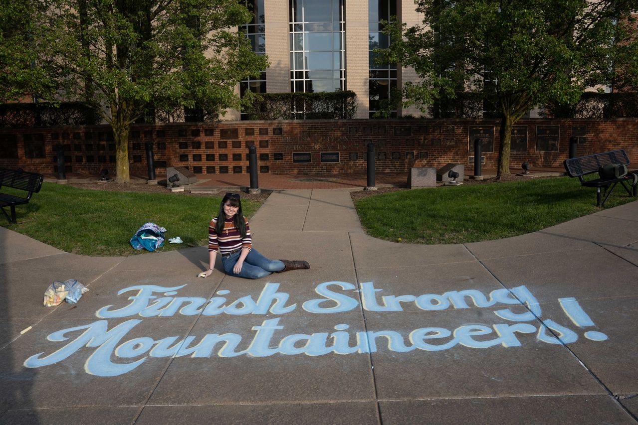 Finish Strong Mountaineers drawn in blue chalk on a sidewalk