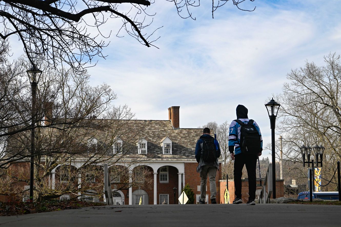 Students walking toward E. Moore Hall on a late winter day.